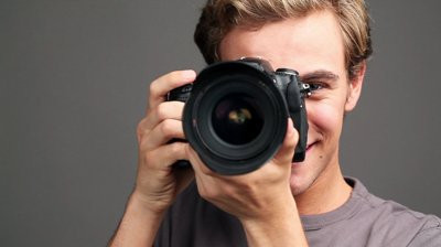 stock-footage-young-man-photographer-taking-photographs-with-digital-slr-camera